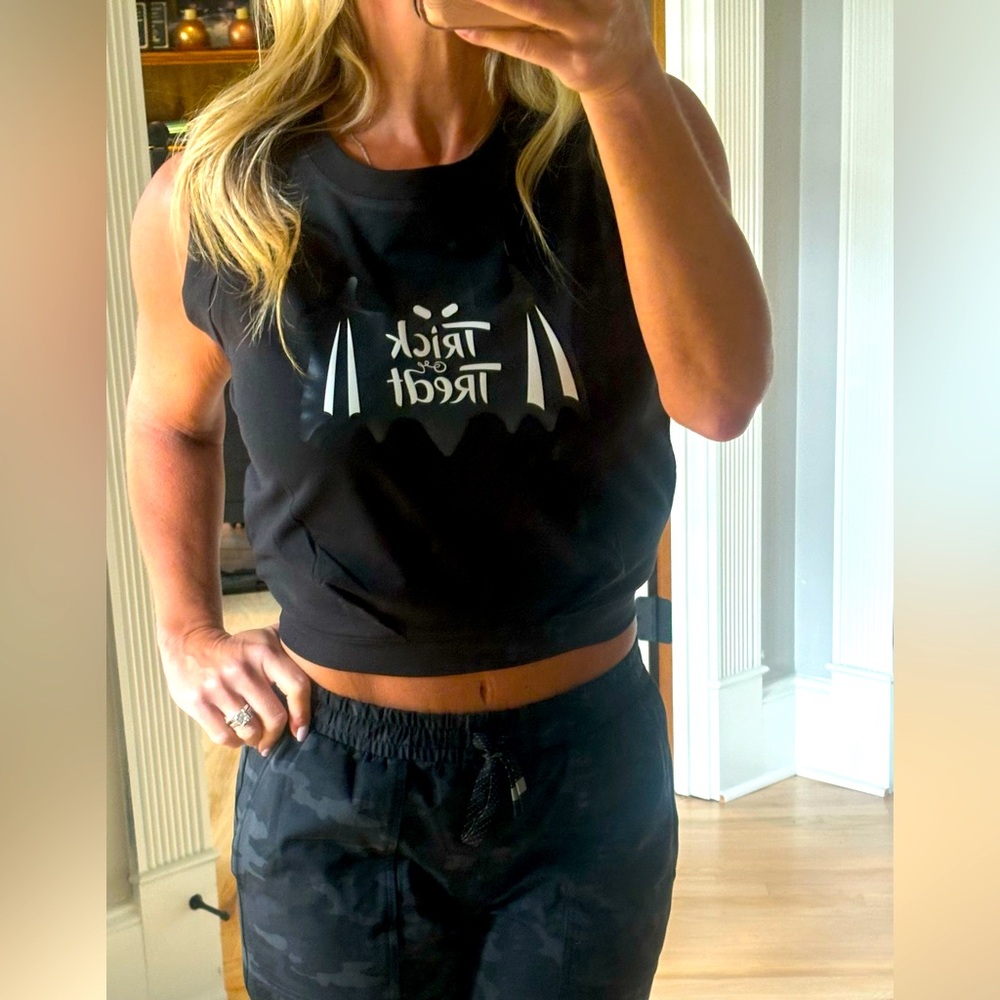 Cute trick or treat crop top.  Large/loose arm holes with fitted waist.